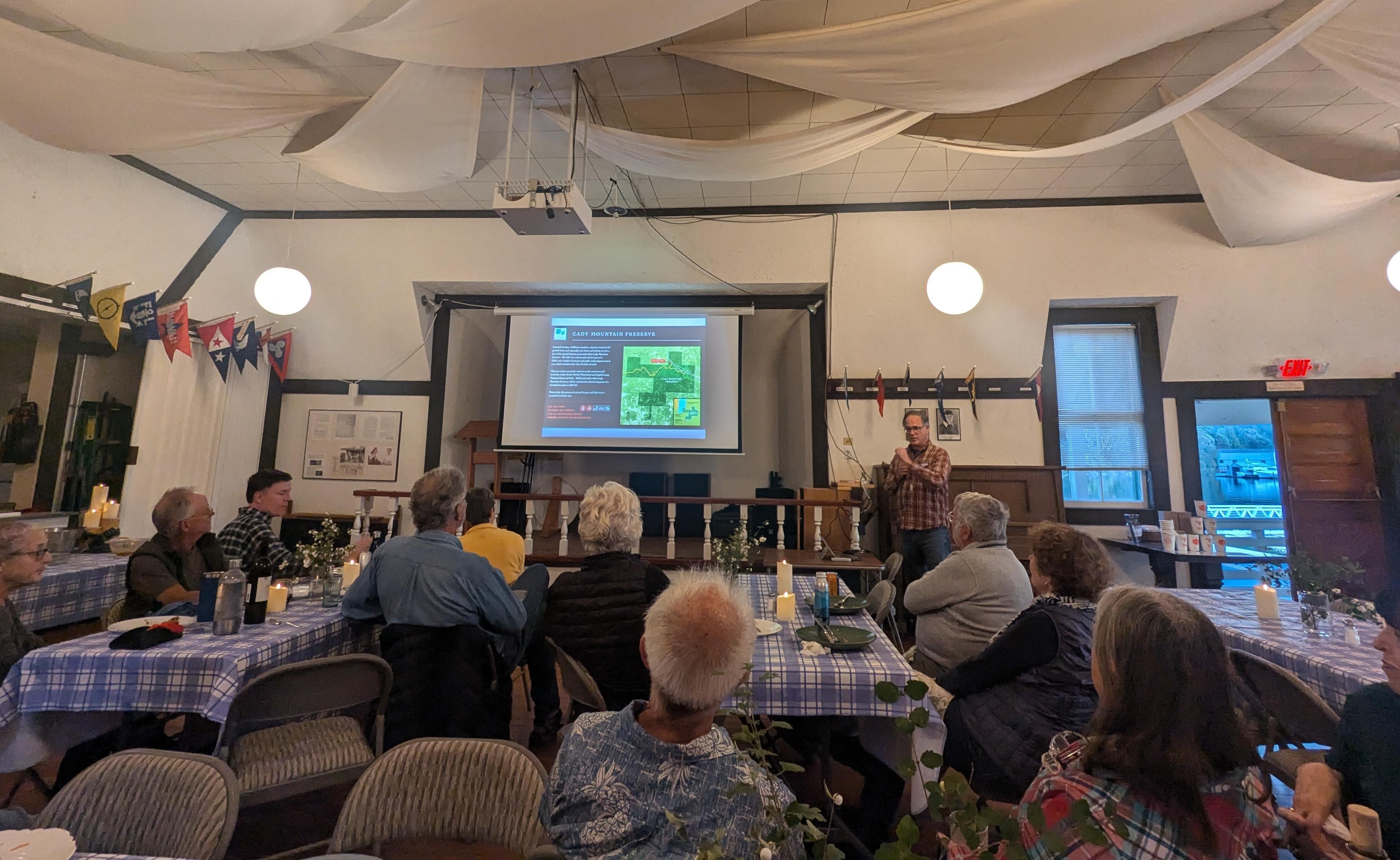 Lincoln Bormann from the SJC Land Bank presenting at the potluck.